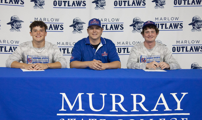 Marlow seniors, Drew Wollenberg, left, and Hunter Miller, right, commit to Murray State College on a shooting scholarship, Thursday, March 14, 2024. This was the second letter of intent for Miller. In mid-February Miller and Lawson Knox signed with MSC on a fishing scholarship. Representing MSC's shooting program is Clay Robertson, assistant coach. His father, Scott, is the head coach of the MSC program. Photo by Toni Hopper/The Marlow Review