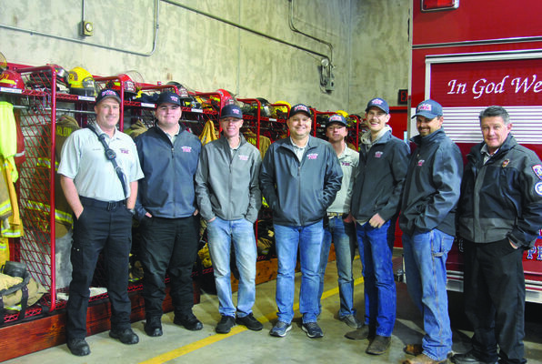 A Place for Everything: Firefighters Shane Linam, Jakob Herriage, Alex Barker, Adam James, Dayton O’Neal, James Bourke, Eric Spurlock, and Michael Pope show off new gear racks that were recently installed thanks to a gift from an anonymous donor.

Photo by Elizabeth Pitts-Hibbard