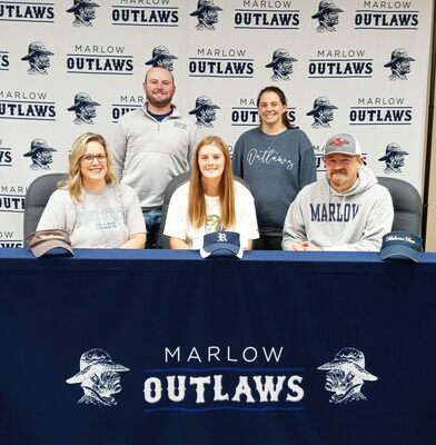 Marlow High School senior Erin Doughty signs a letter of intent with Rose State to play softball, Friday, Nov. 11, 2022, at the Marlow Board of Education office. By her side, are parents Jamie and Dennis Doughty, and behind are her coaches, Trevor Hudgens, softball coach, and Brett Tahah, basketball coach. Photo by Toni Hopper/The Marlow Review