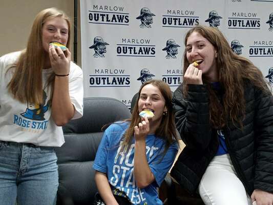 Erin Doughty, Kendall Kizarr and Whitney Wade enjoy some softball frosted cookies after Doughty signed a letter of intent to play ball at Rose State.
Photo by Toni Hopper/The Marlow Review
