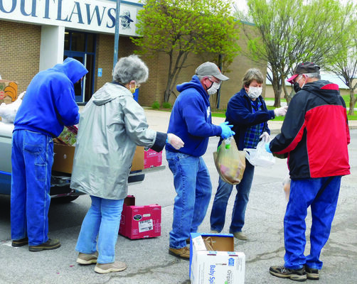 Ike Eisenhlor, Sandy Chatfield, DeWayne Lowe, Carolyn Lowe, and See Chatfield, all volunteer with Marlow Samaritans, assist with distribution of fresh produce that was donated by the Regional Food Bank of Oklahoma.