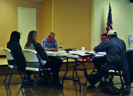 DISTANCING: The Stephens County Commissioners moved their regular meeting to Territory Hall at the Fairgrounds so that attendees could observe social distancing standards, sitting six feet apart while participating.