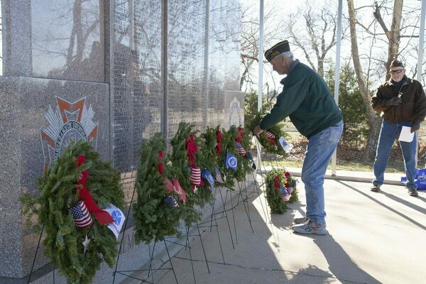 Bobby Cobb with the Marlow VFW Post #4888 places a live balsam fir wreath during the Wreaths Across America ceremony at the Marlow Cemetery, Saturday, Dec. 17, 2022, as Randy Oldham describes each wreath and the military branch it honors and those who served or are serving. Additionally, there are 93,129 United States service men and women from all branches who last known status was either Prisoners of War or Missing in Action. Photo by Toni Hopper/The Marlow Review