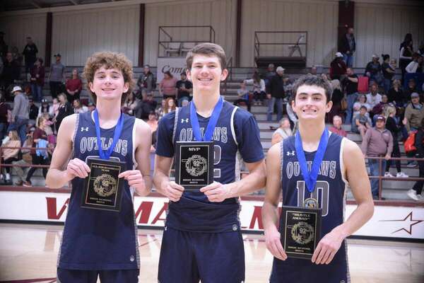 Marlow’s Parker Boyles, Avrey Payne and Blayd Harris show off their medals and plaques earned during the 92nd annual Stephens County Tournament, Saturday at the Velma-Alma gym. Between the three players, they scored 44 total points in the final game, which the Outlaws won, 58-55 after it went into overtime against Velma-Alma. Boyles was named to the All-Tournament Team, Payne received the MVP award, and Harris received the Hustle Award. Outlaws Head Coach Kirk Harris also gave medals to the players. Photo by Toni Hopper/The Marlow Review