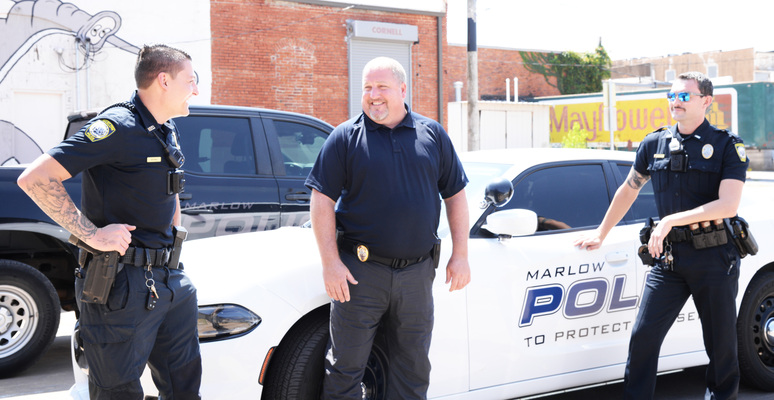 Marlow Police Chief Ronnie Smith, center, shares a laugh with two of his officers, Jace Gilley, left, and Lt. Cole Jack, during a break at the station. Photo by Toni Hopper/The Marlow Review