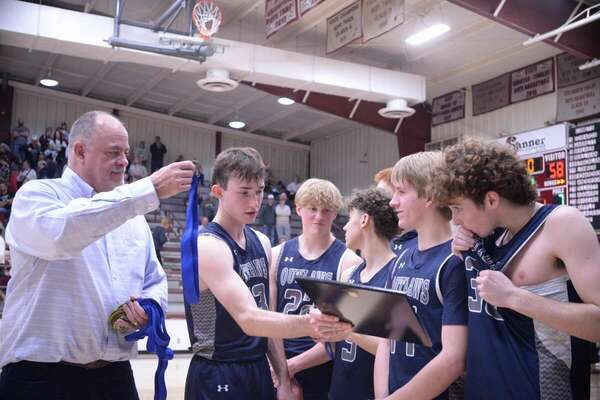 Marlow Head Coach Kirk Harris hands medals to his basketball team players at the 92nd annual Stephens County Tournament, after the team won the championship title game, Saturday, Jan. 21, 2023, at Velma-Alma gym. Photo by Toni Hopper/The Marlow Review