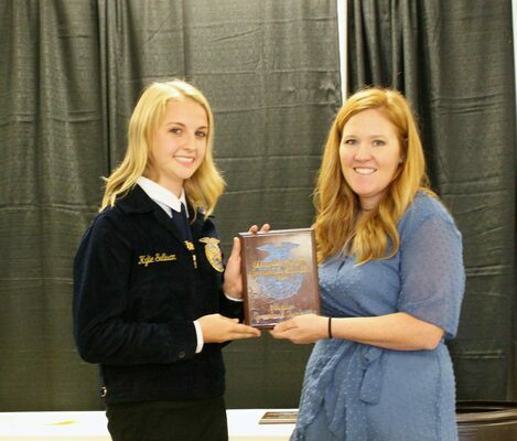 Comanche ag teacher, Shelbi Morgan, presents Kylie Sullivan with her Greenhand degree at the Waurika PI FFA contest Oct. 4, held at the Stephens County Fair &amp; Expo Center in Duncan. SUBMITTED PHOTO