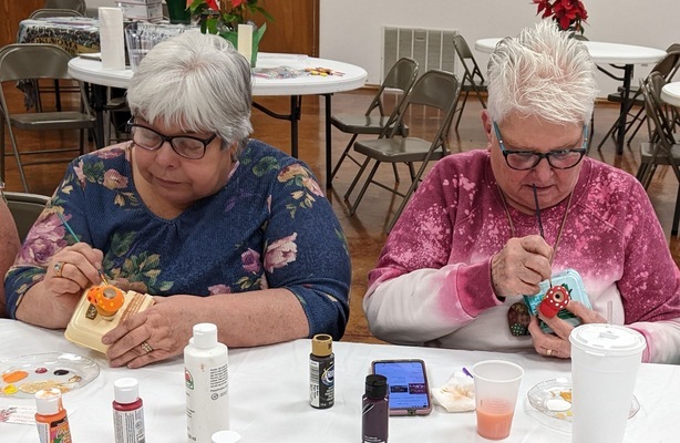 PAINTING WATER FROGS: Annette Davis, left, and Jackie Neely enjoy painting a water frog that will be placed in one of their favorite pots. The frogs will supply needed moisture to their plants that have been brought inside to protect them from the bitter cold of winter.