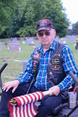 Earl Lavey uses a Toro riding lawnmower as transportation on Saturday, May 27, 2023, in the Marlow Cemetery in Marlow, OK. Lavey is a Vietnam veteran and one of 5 remaining members of the local American Legion chapter. He was there to replace and add flags to the gravestones of buried service members.  Photo by Toni Hopper/The Marlow Review