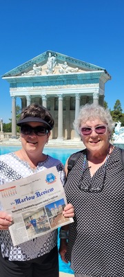 Sarita Wheat and Bridgett Garrett display a copy of The Marlow Review in front of Hearst Castle in San Simeon, CA, in August 2023. Hearst Castle is an official state park and the only art museum operated by California State Parks. Now in October, many tourists visit to see the migration of Monarch butterflies.  The construction of the castle started in 1919, by William Randolph Hearst. The actual history dates to 1865 and a purchase of 40,000 acres of ranchland.