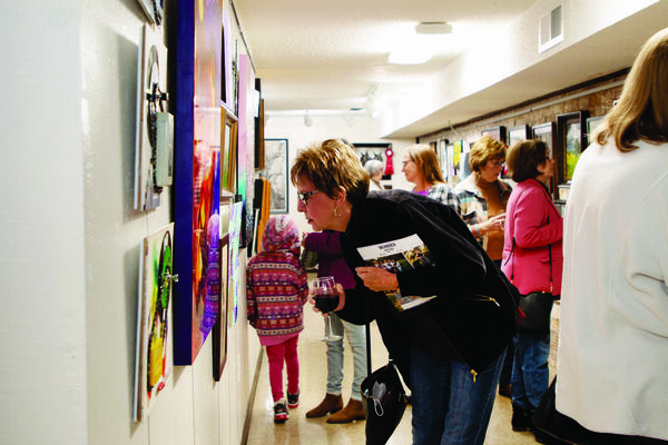 Guests attending the reception for the fifth annual Chisholm Trail Arts Council Holiday Show &amp; Sale study the art on display at the CTAC gallery in Duncan, Nov. 17, 2022. Photo Submitted by Darcy Reeves
