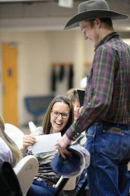 Noah Vanston shares some laughs with Carrie Dickerson after she won the bid for his labor. Photo by Toni Hopper/The Marlow Review