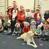 Mrs. Freeman’s kindergarten class poses with the Cat in the Hat and Abby, the therapy dog during the Read Across America event at Marlow Elementary School on Monday.