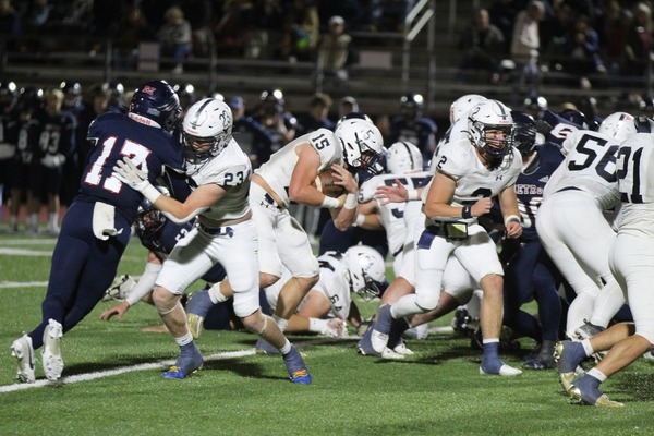Hudson Morgan #15, center, clutches the ball as his teammates Zach Dawson #23 and Cade Gilbert #2, as well as many other Outlaws do their job to protect him. Morgan made a touchdown during the 2nd quarter. Photo by Debbie Green Brown/The Marlow Review