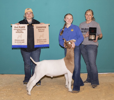 Mardi Scott, center, earned the Reserve Grand Champion Wether Goat during the 86th annual Stephens County Junior Livestock Show that was held Feb. 19-23. She also won the Intermediate Meat Goat Showmanship title. Harley Angeles, left, and Penny Scott, right, hold her banners and buckles. Photo submitted by Chelsea Kennen